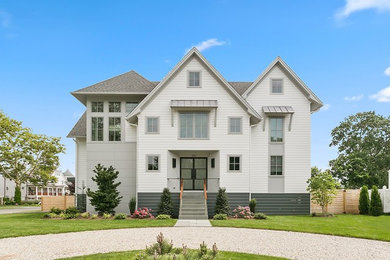 Mid-sized coastal white three-story concrete fiberboard house exterior idea in New York with a shingle roof