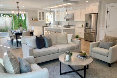 Family room - mid-sized transitional open concept light wood floor family room idea in Boston with beige walls, a standard fireplace, a tile fireplace and a wall-mounted tv