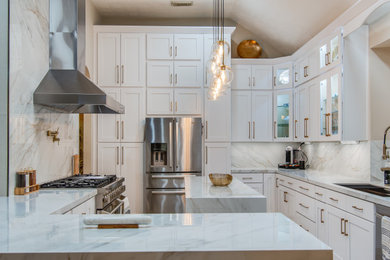 Eat-in kitchen - large modern l-shaped marble floor and beige floor eat-in kitchen idea in Houston with an undermount sink, shaker cabinets, white cabinets, solid surface countertops, white backsplash, porcelain backsplash, stainless steel appliances, an island and white countertops