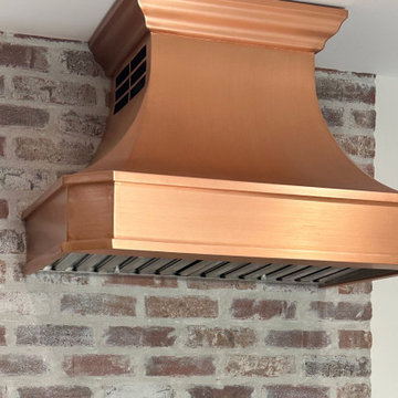 Kansas Copper Range Hood: Blending Rustic Brick Charm in Kitchen