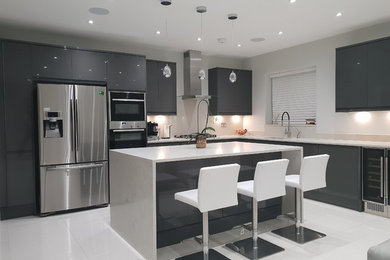 Design ideas for a large contemporary l-shaped open plan kitchen in London with a built-in sink, flat-panel cabinets, grey cabinets, quartz worktops, beige splashback, porcelain splashback, stainless steel appliances, porcelain flooring, an island, white floors and white worktops.