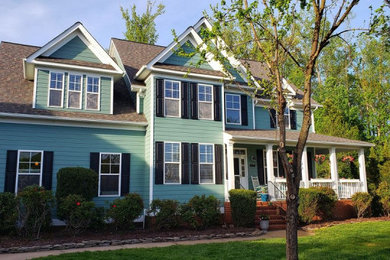 Mid-sized traditional blue two-story house exterior idea in Other