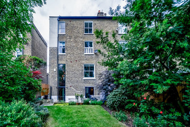 This is an example of a contemporary rear house exterior in London.