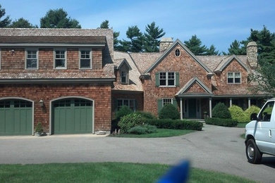 Example of a red two-story brick exterior home design in Boston