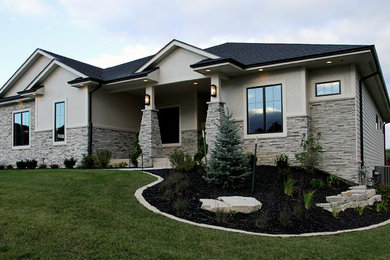 Mid-sized transitional gray two-story mixed siding exterior home idea in Other with a hip roof