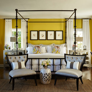 Photo of a mid-sized transitional master bedroom in Miami with yellow walls, dark hardwood floors, no fireplace and brown floor.