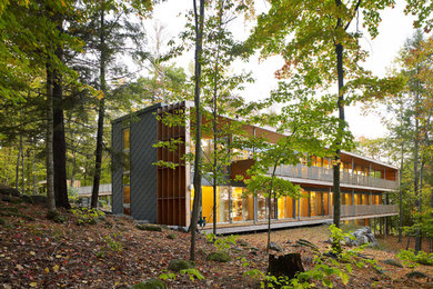 Large trendy gray two-story metal exterior home photo in Toronto