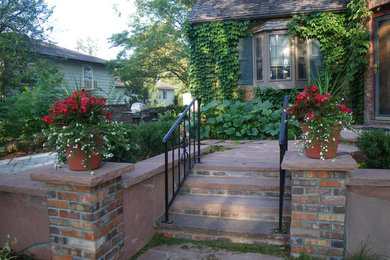 Mid-sized elegant stone front porch photo in Denver