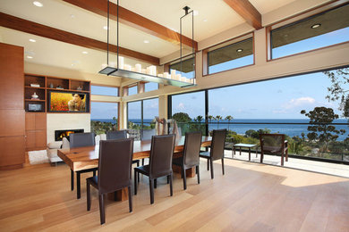 Example of a huge trendy light wood floor dining room design in Orange County with beige walls, a standard fireplace and a stone fireplace