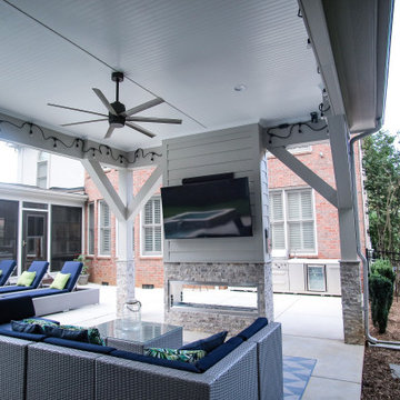 Elegant Covered Patio with Fireplace and TV with Beadboard Ceiling