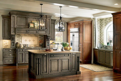 Large elegant galley dark wood floor open concept kitchen photo in San Francisco with a double-bowl sink, raised-panel cabinets, dark wood cabinets, laminate countertops, beige backsplash, porcelain backsplash, an island and stainless steel appliances