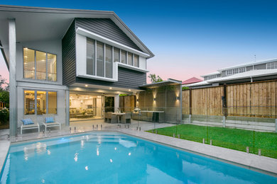 Inspiration for a large contemporary backyard rectangular pool in Brisbane with tile.