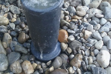 Photo of a mid-sized contemporary drought-tolerant and partial sun backyard water fountain landscape in Richmond for spring.