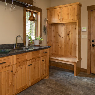 Design ideas for a medium sized rustic single-wall utility room in Other with a built-in sink, shaker cabinets, distressed cabinets, granite worktops, beige walls, laminate floors and grey floors.