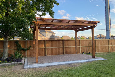 Patio - large backyard patio idea in Austin with a pergola
