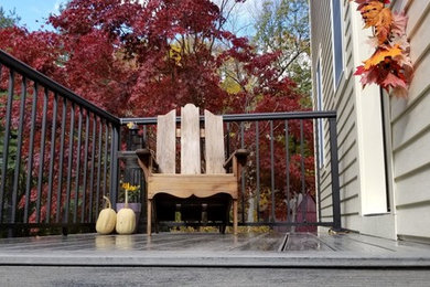 Inspiration for a mid-sized timeless yellow two-story vinyl house exterior remodel in Boston with a hip roof and a shingle roof