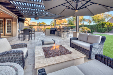 Patio kitchen - large contemporary backyard concrete paver patio kitchen idea in Phoenix with a pergola