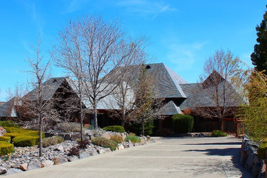 Inspiration for a large timeless gray two-story stone exterior home remodel in Other