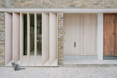 Design ideas for a medium sized rustic front door in London with white walls, a single front door and a light wood front door.
