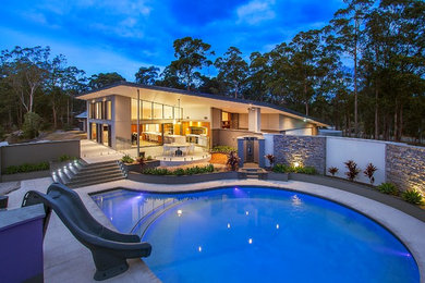 Photo of a large contemporary side yard round pool in Brisbane with tile.