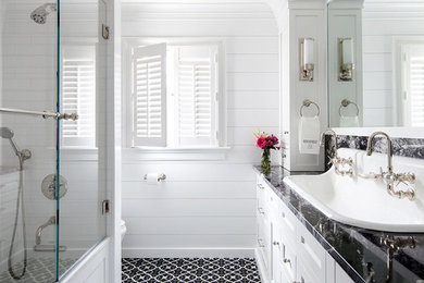 Bathroom - transitional master mosaic tile floor and black floor bathroom idea in New York with shaker cabinets, white cabinets, white walls, a drop-in sink and black countertops