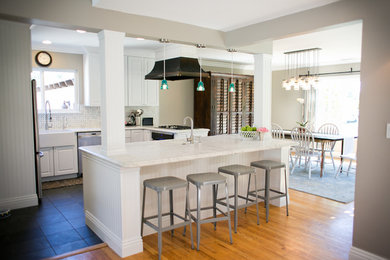 Eat-in kitchen - coastal slate floor eat-in kitchen idea in Santa Barbara with an island, raised-panel cabinets, white cabinets, marble countertops, multicolored backsplash, mosaic tile backsplash, stainless steel appliances and a farmhouse sink