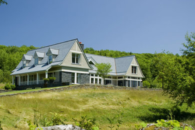 Elegant beige two-story wood exterior home photo in Other
