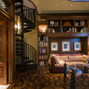 Photo of a large traditional home office in Detroit with a library, beige walls, cork floors and a freestanding desk.