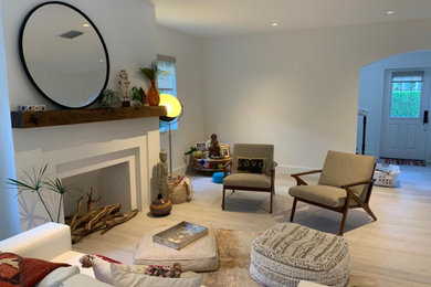 Living room - large modern open concept light wood floor and beige floor living room idea in Miami with white walls, a standard fireplace, a plaster fireplace and no tv