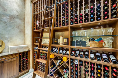 This is an example of a mid-sized mediterranean wine cellar in Dallas with storage racks.