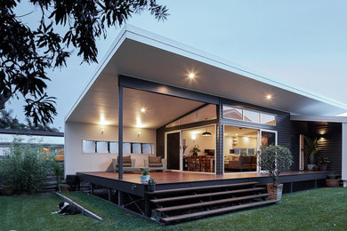 Photo of a small beach style backyard deck in Gold Coast - Tweed with a roof extension.