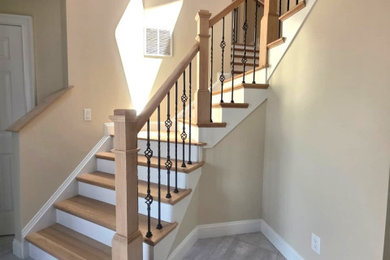 Staircase - mid-sized contemporary wooden curved mixed material railing staircase idea in New York with wooden risers