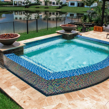 Swim Spa With Custom Fire Bowls and Outdoor Kitchen in Cooper City, Florida