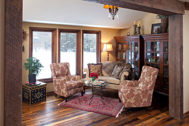 Mountain style medium tone wood floor and vaulted ceiling living room photo in Minneapolis with beige walls