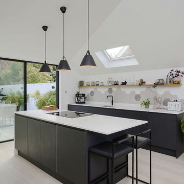 Contemporary black & white kitchen with full height glazed sliding doors