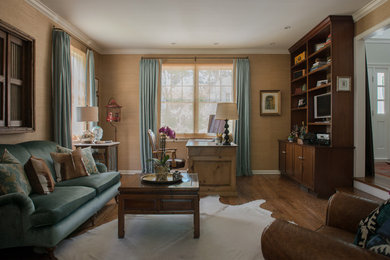 Home office library - mid-sized traditional freestanding desk medium tone wood floor and brown floor home office library idea in New York with beige walls