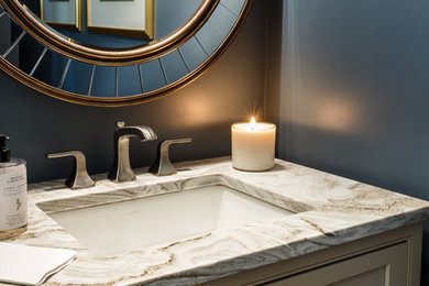 Inspiration for a small transitional powder room remodel in DC Metro with beige cabinets, blue walls, an undermount sink and multicolored countertops