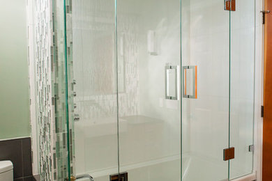 Inspiration for a mid-sized contemporary master multicolored tile and glass tile porcelain tile bathroom remodel in Calgary with medium tone wood cabinets, green walls, a vessel sink and granite countertops