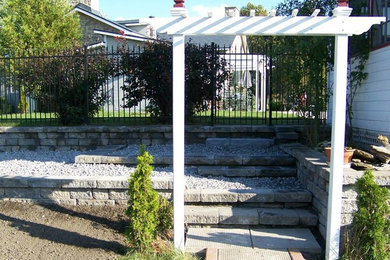 This is an example of a garden in Toronto with a retaining wall.