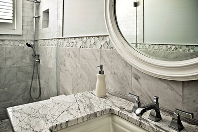 Double shower - mid-sized coastal master gray tile and glass tile porcelain tile double shower idea in Philadelphia with an undermount sink, flat-panel cabinets, white cabinets, granite countertops, a one-piece toilet and gray walls
