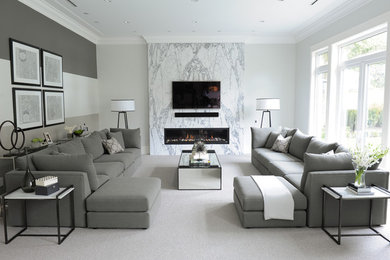 Photo of a mid-sized transitional open concept family room in Vancouver with white walls, carpet, a ribbon fireplace, a stone fireplace surround and a wall-mounted tv.