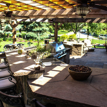 Incredible Outdoor Kitchen and Paver Patio With Fire Bowl