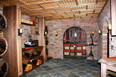 Mid-sized tuscan ceramic tile wine cellar photo in New York