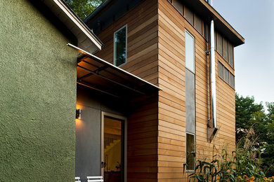 Inspiration for a modern green two-story mixed siding exterior home remodel in Other