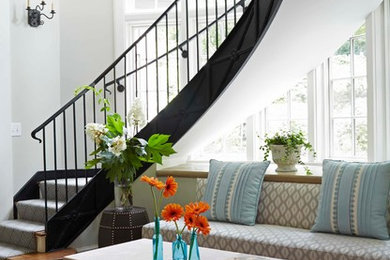 Design ideas for a large transitional wood curved staircase in Birmingham with painted wood risers.