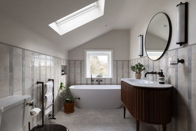 Freestanding bathtub - mid-sized contemporary master gray tile and ceramic tile ceramic tile, gray floor and single-sink freestanding bathtub idea in Other with quartzite countertops, white countertops, a freestanding vanity, dark wood cabinets, white walls and an integrated sink