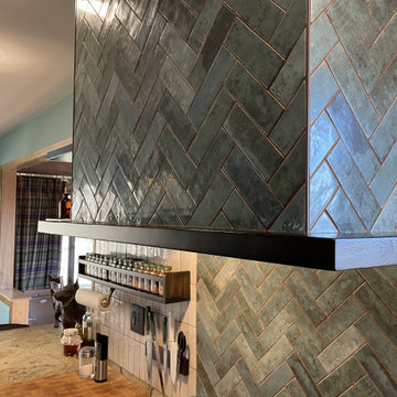 Birch Slab Door Kitchen with Green Tile, Hypnose Stone Tops, and MCM Lighting