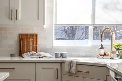 Inspiration for a mid-sized timeless u-shaped medium tone wood floor and brown floor eat-in kitchen remodel in Salt Lake City with an undermount sink, recessed-panel cabinets, yellow cabinets, quartz countertops, white backsplash, subway tile backsplash, stainless steel appliances, an island and multicolored countertops