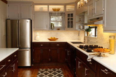 Enclosed kitchen - mid-sized transitional u-shaped light wood floor enclosed kitchen idea in Atlanta with an undermount sink, recessed-panel cabinets, dark wood cabinets, quartz countertops, white backsplash, stone tile backsplash, stainless steel appliances and an island