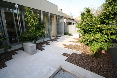 This is an example of a large contemporary entryway in Melbourne with travertine floors.